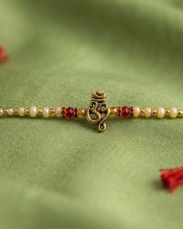 Fancy Golden Om White & Red Beads Rakhi